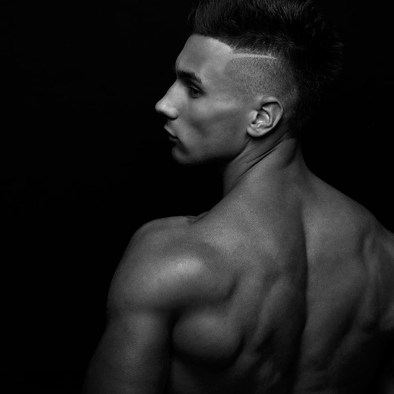 A man's skin fade, black and white, in side profile